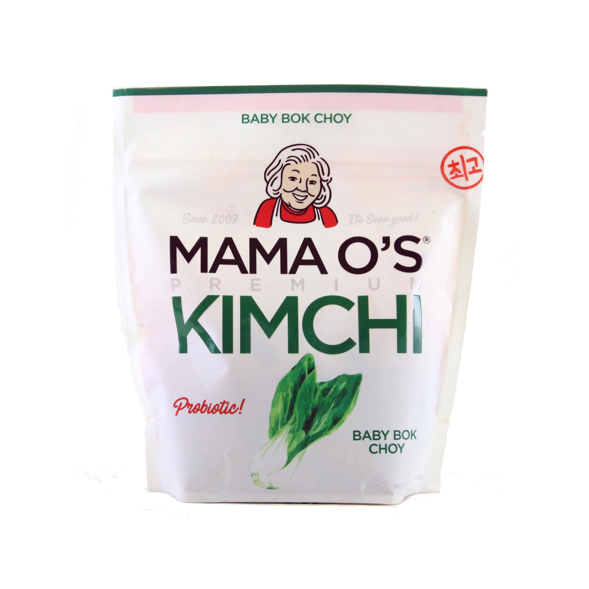 A white package of Mama Os Premium Baby Bok Choy Kimchi features an older womans face, green and pink text, and bok choy images—ideal for kimchi lovers. Brand: Mama Os Premium Kimchi.