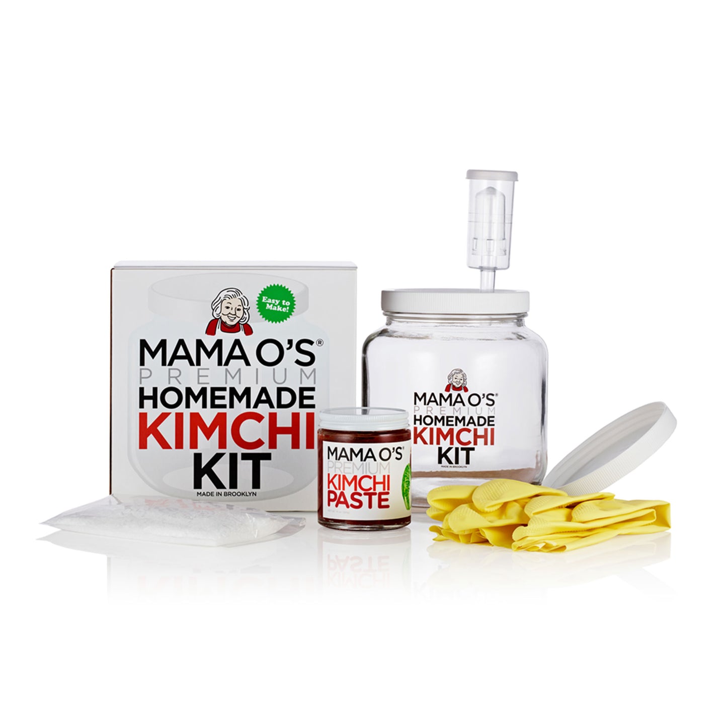 Mama Os Premium Kimchi Kit by Mama Os Premium Kimchi includes a jar, lid, kimchi paste jar, gloves, fermentation airlock, and recipe booklet—everything you need to make vegan kimchi at home. All items are displayed on a white background.